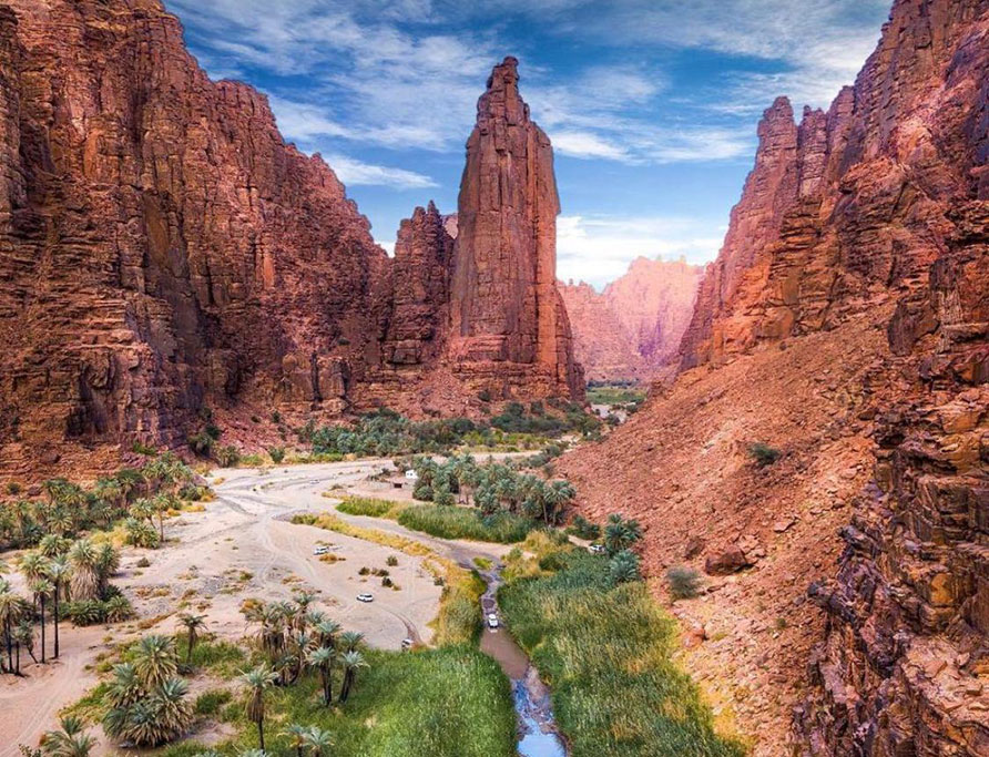 Wadi Disah sandstone canyon and palm trees in Saudi Arabia